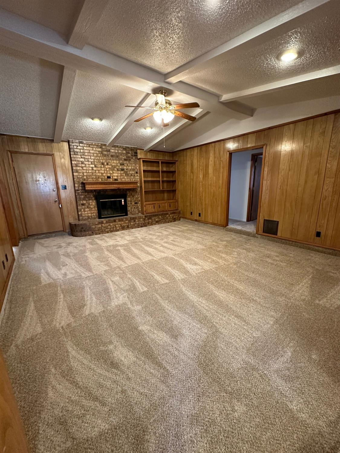 5609 88th Street Lubbock, TX 79424 - Photo 7 of 21 a view of an empty room with a fireplace