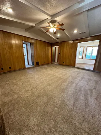 a view of an empty room with window and fireplace