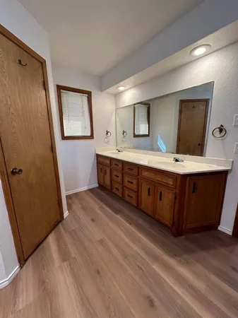 a room with wooden floors and wooden cabinets