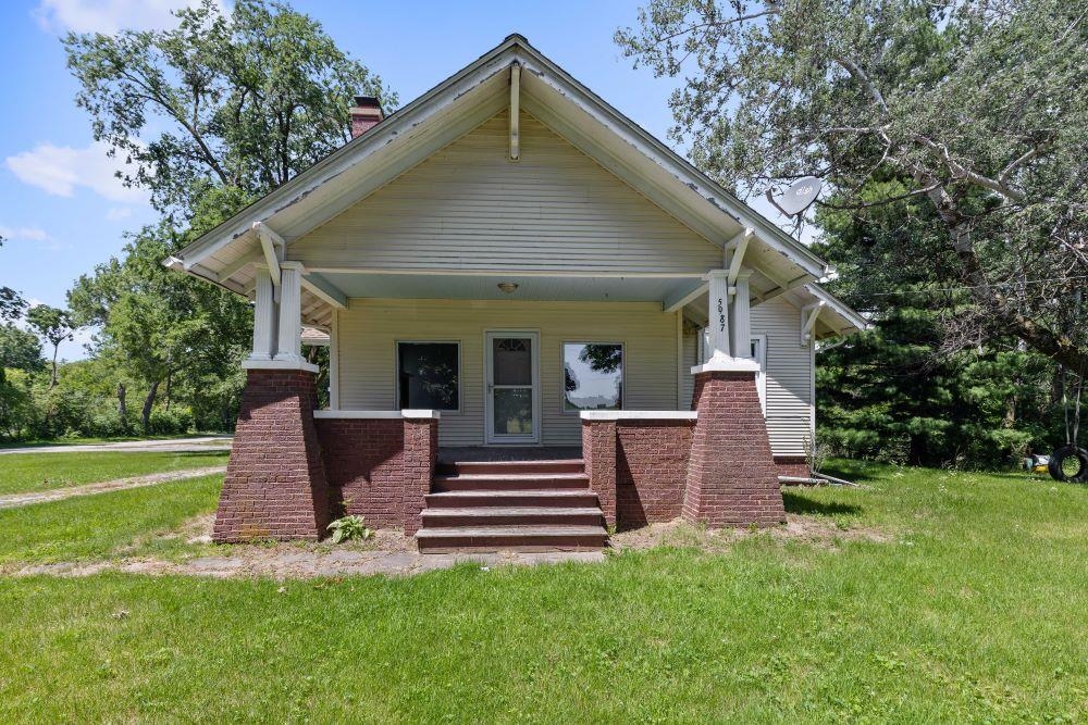 5987 Prairie Road Rockford, IL 61102 - Photo 1 of 21 a front view of a house with a garden and yard
