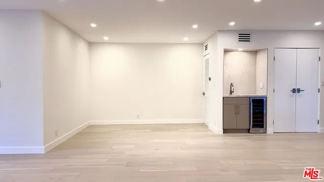 an empty room with closet and entryway