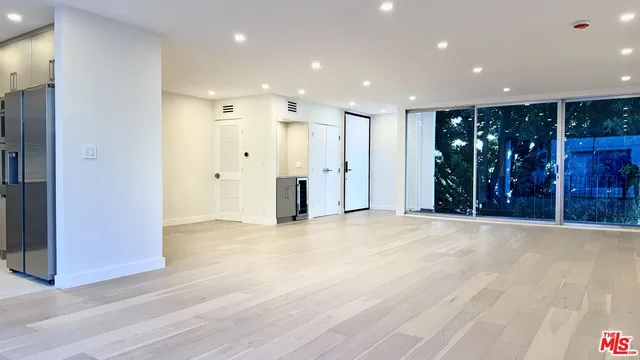 a view of hallway with wooden floor