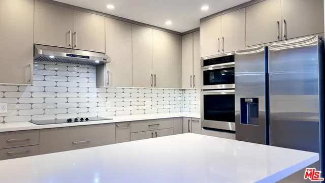 a kitchen with stainless steel appliances a refrigerator and a sink