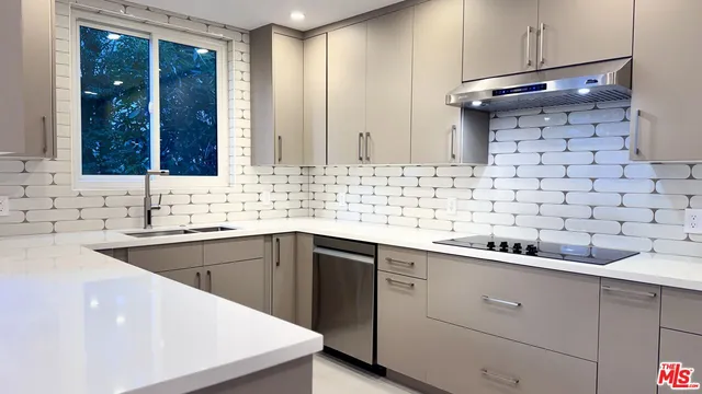 a kitchen with a sink and cabinets