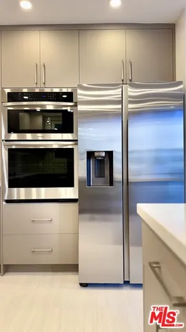 a stove top oven sitting inside of a kitchen