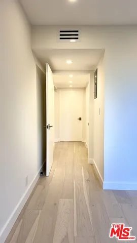 a view of an empty room and wooden floor