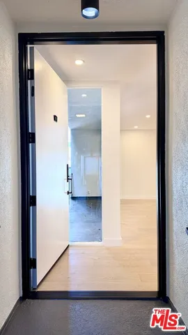 a view of hallway with wooden floor