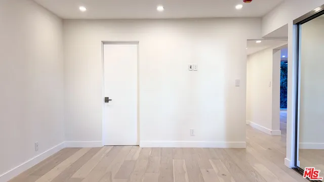 a view of hallway with wooden floor