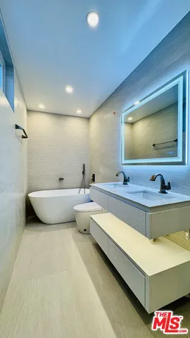 a bathroom with a double vanity sink and mirror