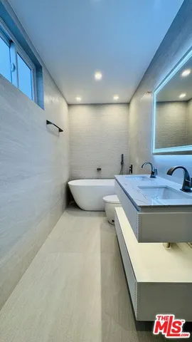a en suite bathroom with a double vanity sink and a mirror