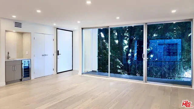 an empty room with sliding glass door and shower