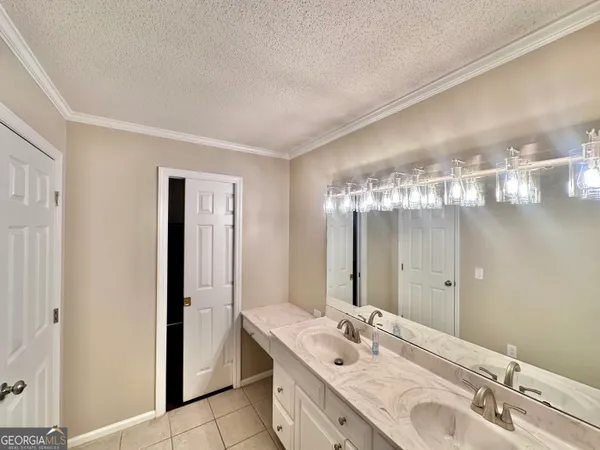 a bathroom with a double vanity sink and a mirror