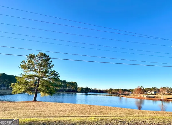 a view of a house with a yard and garage