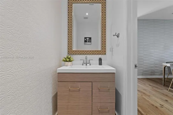 a bathroom with a sink and a mirror