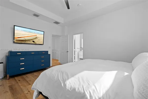 a bedroom with a bed and a flat screen tv