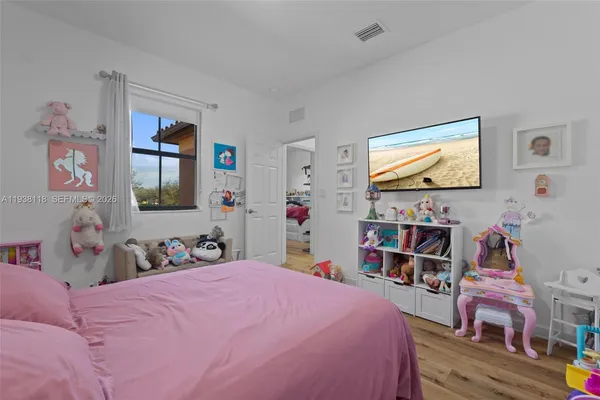 a bedroom with bed and a bookshelf