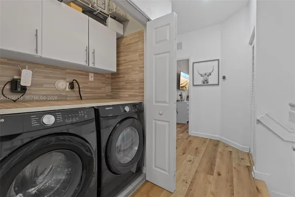 a utility room with sink dryer and washer