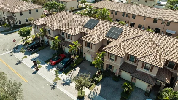 an aerial view of a house with a yard