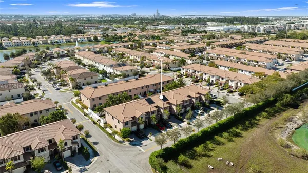 an aerial view of residential houses with outdoor space