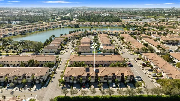an aerial view of residential building and lake