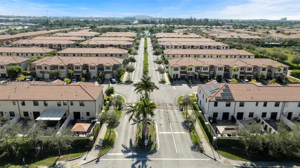 an aerial view of multiple houses with a yard