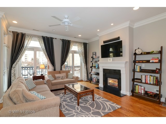 220 North Halsted Street, Unit 2 Chicago, IL 60661 - Photo 2 of 13 a living room with furniture a fireplace and a flat screen tv