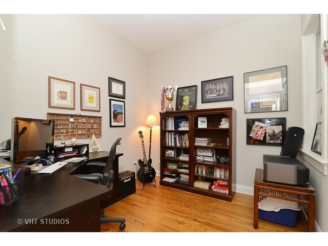 220 North Halsted Street, Unit 2 Chicago, IL 60661 - Photo 11 of 13 a living room with furniture a flat screen tv and bookshelf