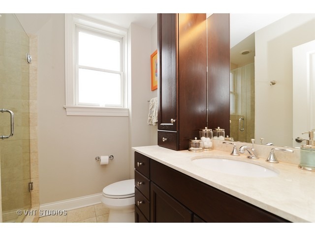 220 North Halsted Street, Unit 2 Chicago, IL 60661 - Photo 12 of 13 a bathroom with a sink vanity mirror and toilet