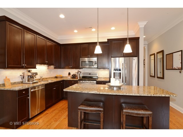 220 North Halsted Street, Unit 2 Chicago, IL 60661 - Photo 4 of 13 a kitchen with stainless steel appliances granite countertop a sink a stove and a refrigerator