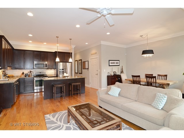 220 North Halsted Street, Unit 2 Chicago, IL 60661 - Photo 5 of 13 a living room with stainless steel appliances kitchen island granite countertop furniture and a large window