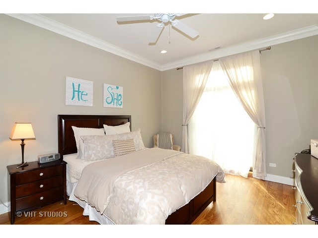 220 North Halsted Street, Unit 2 Chicago, IL 60661 - Photo 7 of 13 a bedroom with a bed and a window