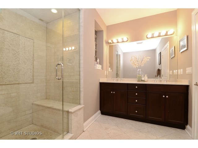 220 North Halsted Street, Unit 2 Chicago, IL 60661 - Photo 8 of 13 a bathroom with a sink vanity granite shower and a mirror