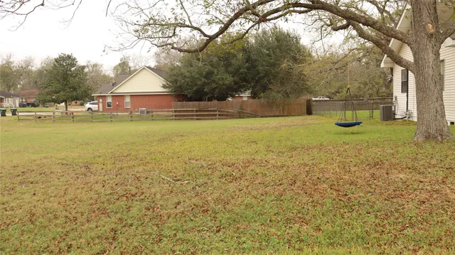 a view of a house with yard and lake view