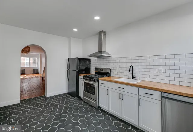 a kitchen with a sink stove and refrigerator