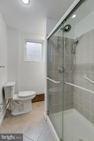 a bathroom with a toilet and a shower