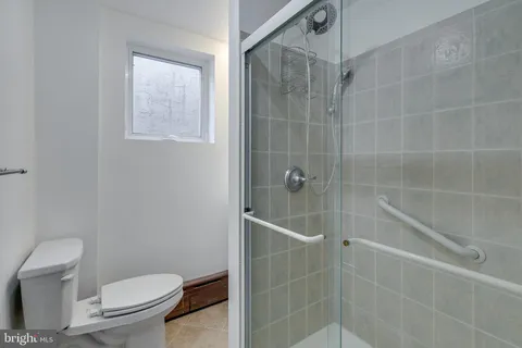 a bathroom with a toilet and shower