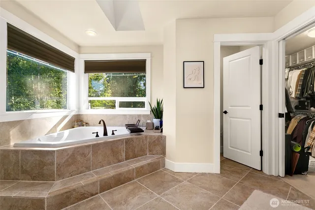 a en suite bathroom with a double vanity sink a mirror and a shower