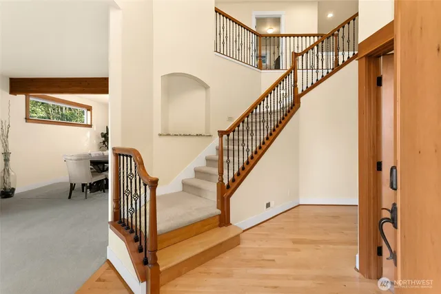 a view of entryway and hall with wooden floor