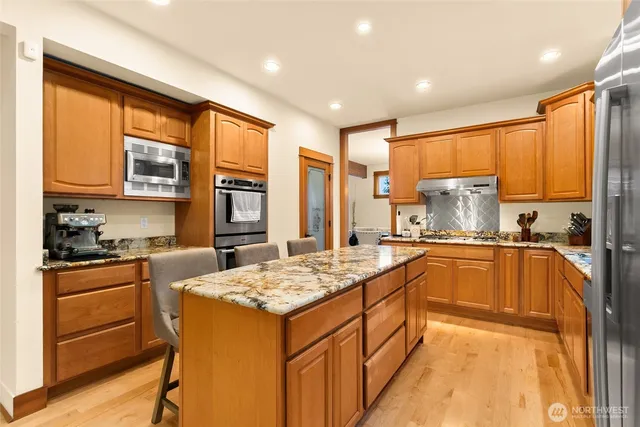 a kitchen with a stove a sink and a refrigerator