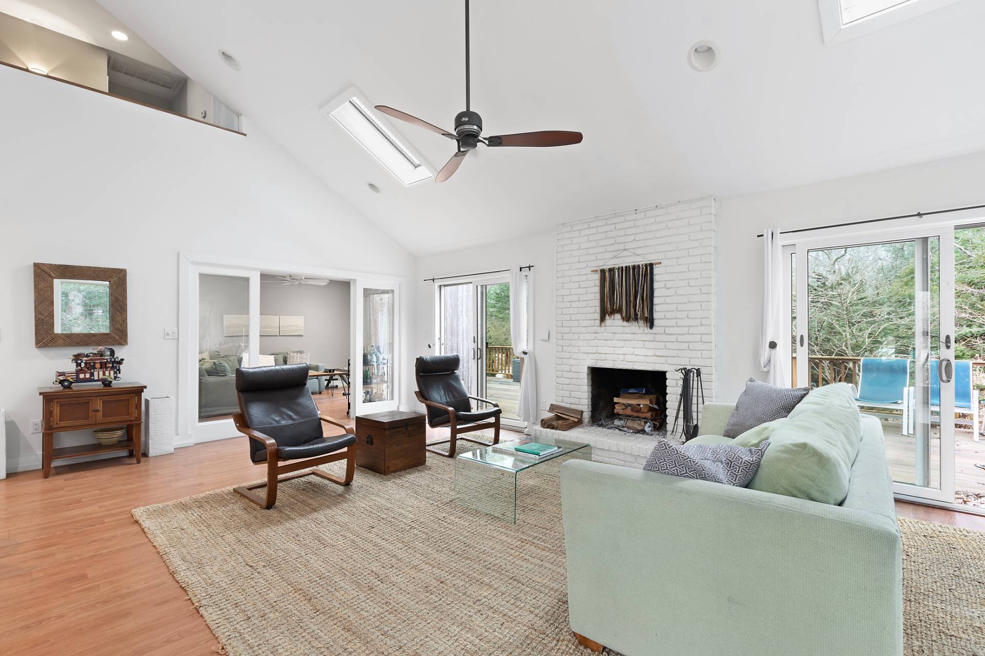 18 Renees Way East Hampton, NY 11937 - Photo 2 of 6 a living room with furniture a fireplace and a floor to ceiling window