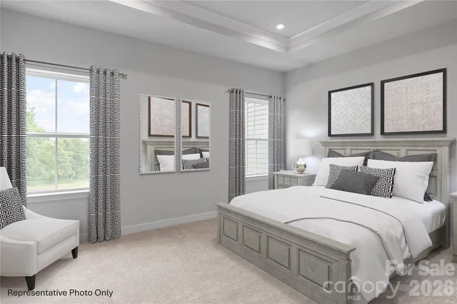 a bedroom with a large bed and windows