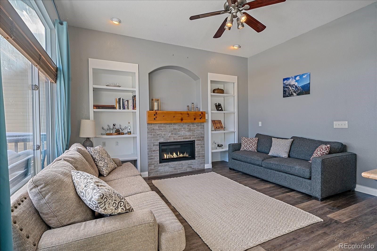 722 Calgary Way Golden, CO 80401 - Photo 14 of 50 a living room with furniture and a fireplace
