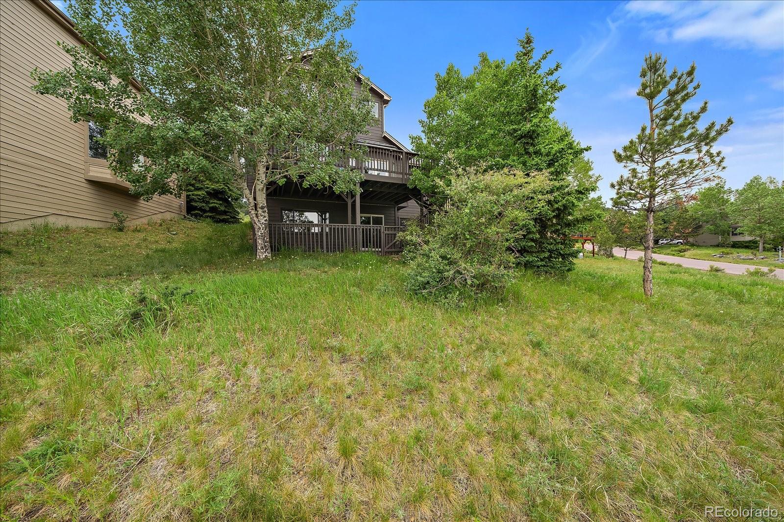 722 Calgary Way Golden, CO 80401 - Photo 45 of 50 a backyard of a house with plants and tree