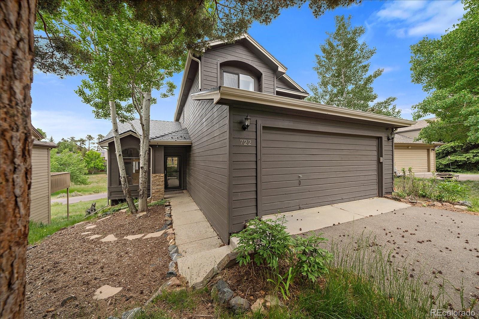 722 Calgary Way Golden, CO 80401 - Photo 5 of 50 a front view of a house with a yard and garage
