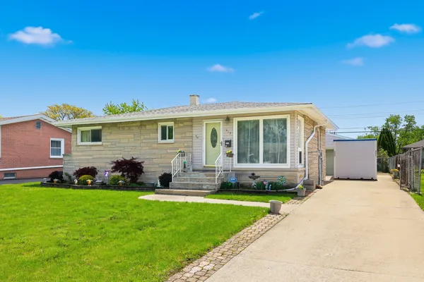 a front view of a house with a yard and outdoor seating