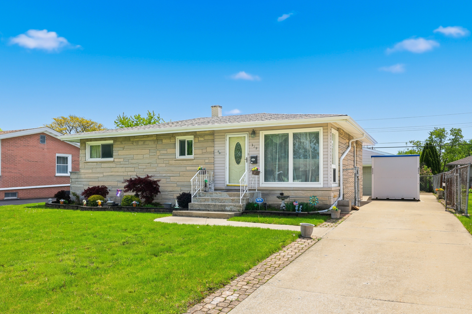 329 East Myrick Avenue Addison, IL 60101 - Photo 1 of 30 a front view of a house with a yard and outdoor seating