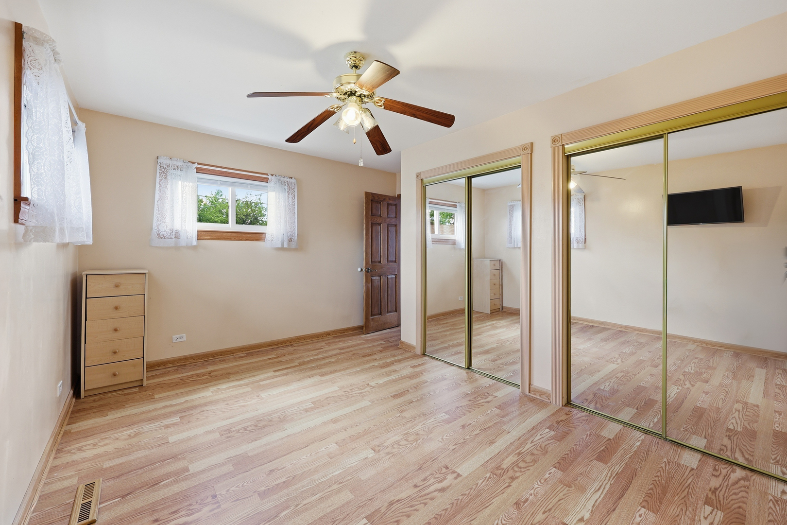 329 East Myrick Avenue Addison, IL 60101 - Photo 11 of 30 a view of empty room with wooden floor and fan