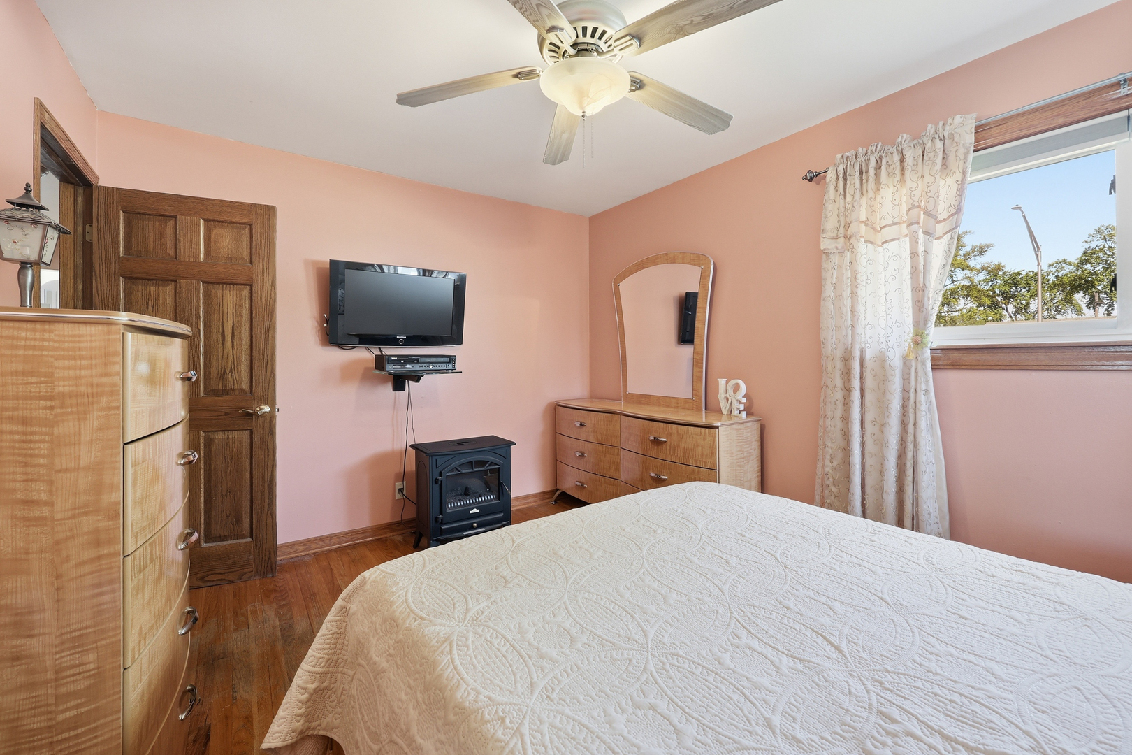 329 East Myrick Avenue Addison, IL 60101 - Photo 14 of 30 a bedroom with a bed and a flat tv screen on dresser