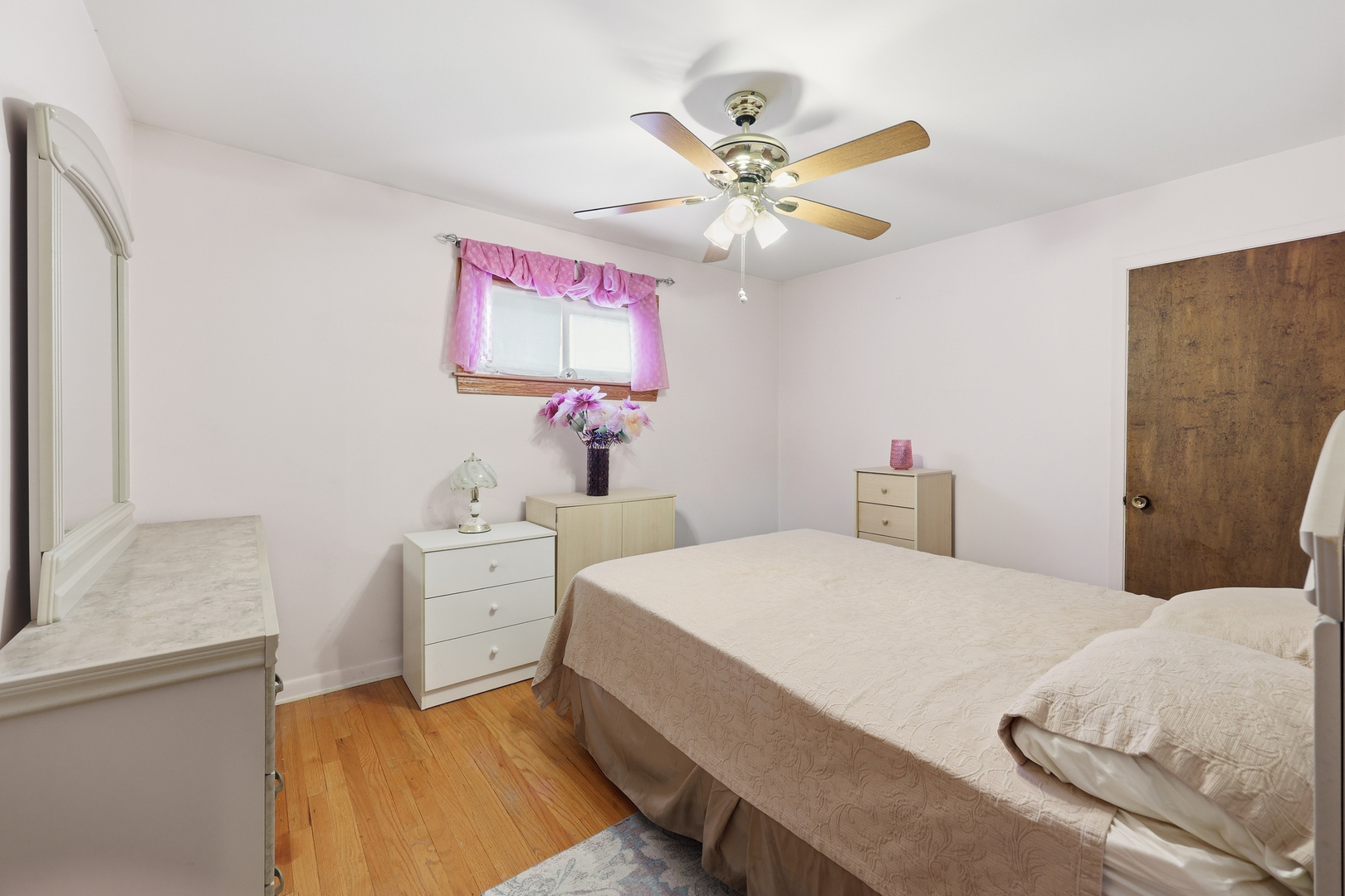 329 East Myrick Avenue Addison, IL 60101 - Photo 16 of 30 a bedroom with a bed and a chandelier