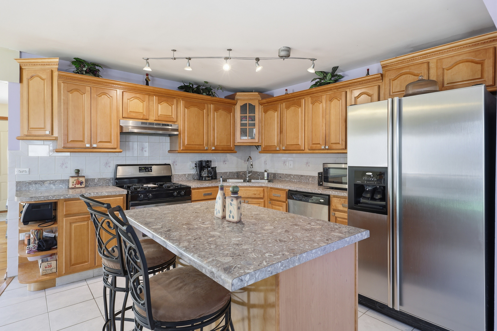 329 East Myrick Avenue Addison, IL 60101 - Photo 2 of 30 a kitchen with a table chairs refrigerator and cabinets